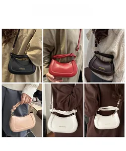 Multiple colors of half-moon handbags featuring trendy knot handles and gold logo details