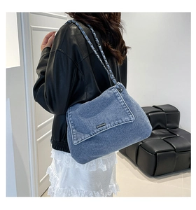 Blue denim chain tote bag shown on model highlighting the stylish wash and large size
