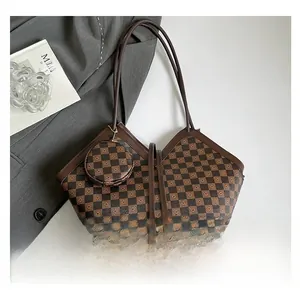 Detail of checkered tote bag with matching round coin purse on a minimalist background