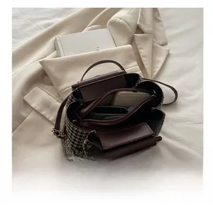 Interior view of houndstooth tote bag showing large capacity and brown leather details
