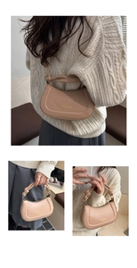 Detail view of beige crescent bag with knotted handle and detachable shoulder strap