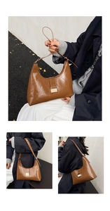 Detail of vintage brown semi-circle hobo bag featuring a gold rectangular metal buckle