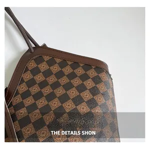 Detail view of the brown checkerboard textured leather and precision stitching on the tote