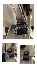 Detail of houndstooth crossbody bag with wooden handle and black leather accents