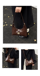 Detail of a brown oil wax leather croissant shoulder bag with a gold metal clasp