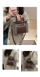 Detail of vintage houndstooth tote featuring brown leather trim and gold metal hardware