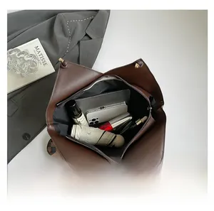 Internal view of dark brown tote bag showing capacity for tablet, umbrella and makeup