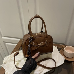 Vintage brown leather handbag with gold buckles and adjustable shoulder strap for women