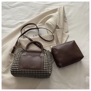 Close-up of houndstooth patchwork handbag set with brown leather sub-bag and strap