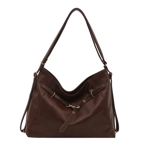 Large dark brown leather tote bag with decorative straps and adjustable shoulder strap