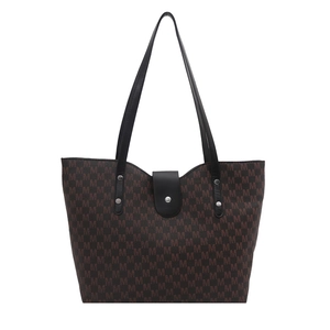 Brown monogram tote bag with black leather straps and silver rivet details