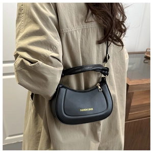 Detail of black crescent hobo bag with gold text and stylish knotted handle detail