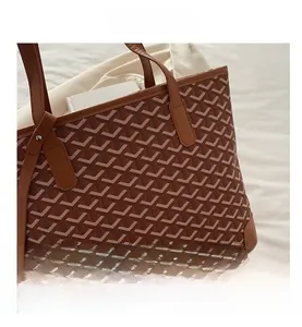 Detail view of large tote bag with brown chevron print and leather reinforced corners