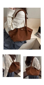 Detail shot of the dark brown suede tote bag featuring a decorative metal buckle and strap