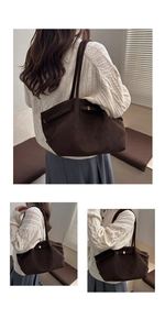 Detail of dark brown faux suede tote bag featuring adjustable sides and golden metal clasp