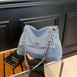 Light blue denim tote bag with chain strap and metal clasp for casual everyday commuting