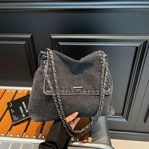 Dark grey washed denim chain tote bag with silver metal bar and flap closure