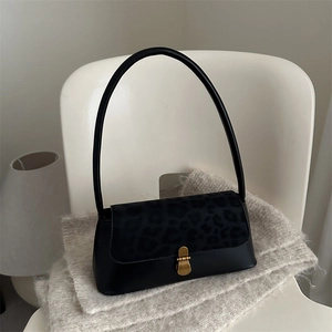 Minimalist leopard print shoulder bag with black leather and gold metal buckle detail