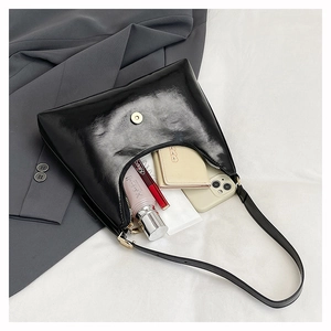 Detail view of large capacity black hobo bag interior with zip and magnetic closure