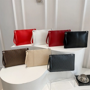 Fashionable envelope clutches in multiple colors with classic geometric textures and wristlets