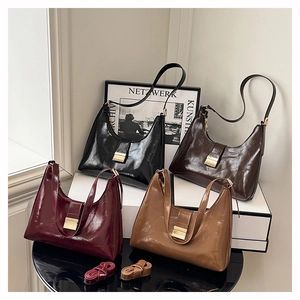 Detail view of smooth leather dumpling bags in multiple colors with metallic buckles