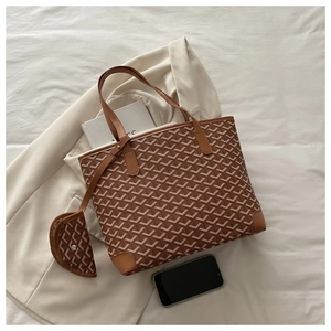 Detail of printed tote bag and pouch set on a blazer backdrop for daily commute