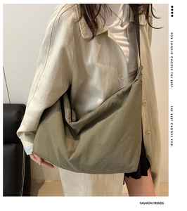 Olive green large capacity tote bag with wide black strap and crinkled texture fabric
