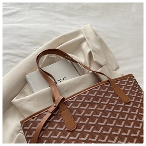 Detailed macro view showing the large capacity and chevron print of this brown tote bag