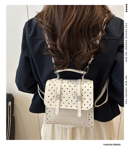 Polka dot backpack in cream PU leather with metal buckles on model back view