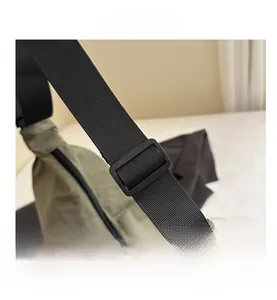Detail shot of the adjustable black nylon shoulder strap with a durable plastic buckle
