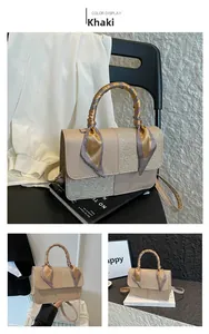 Detailed shot of khaki patchwork handbag with sparkly texture and silk scarf handle