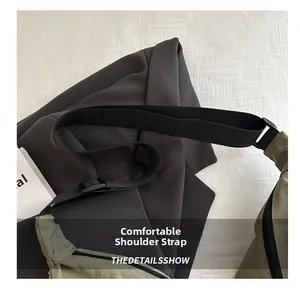 Adjustable nylon shoulder strap detail on a large olive green casual crossbody dumpling bag