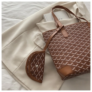 Detailed macro view of the Y-pattern canvas tote bag with matching leather pouch