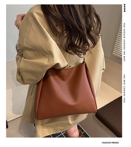 Brown faux leather tote bag detail showing minimalist stitching and large capacity