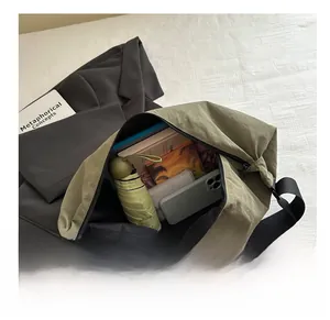 Interior view showing large capacity of army green crossbody bag with daily essentials