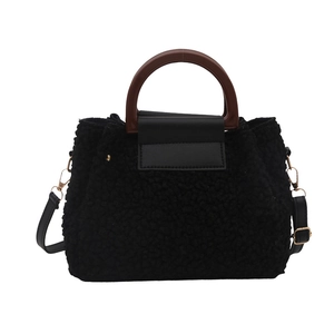 Retro black faux shearling handbag with brown wood-texture handle and crossbody strap