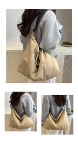 Detail view of khaki large capacity tote bag with soft fabric and black wide shoulder strap