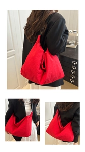 Detail view of large red nylon tote bag showing lightweight fabric and minimalist design