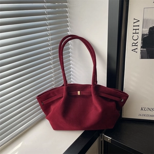 Fashionable burgundy suede tote bag with gold buckle in minimalist silhouette