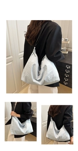 Detail of light blue slouchy tote bag showing the crinkled nylon texture and wide strap