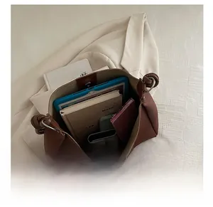 Top view of brown leather bucket bag showing large interior for tablets and daily essentials