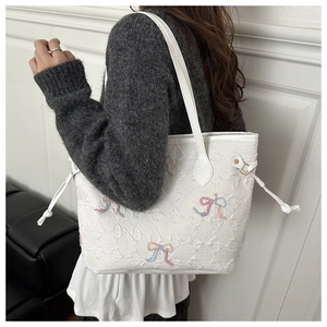 Détail du grand sac cabas blanc matelassé avec broderies nœuds colorés et cordon latéral