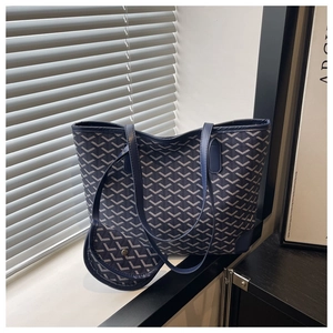 Detail of navy tote bag set featuring geometric patterns and premium leather trim finish