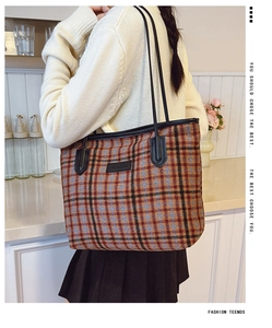 Detail view of plaid tweed tote bag with leather straps for autumn winter casual wear