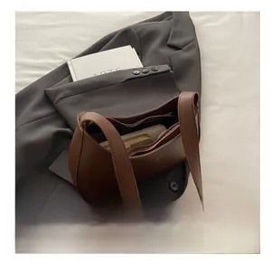 Spacious interior of brown leather Hobo bag showing storage for phone and wallet