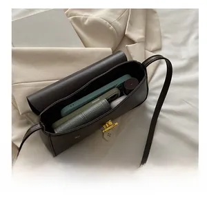 Interior view of dark brown retro shoulder bag showing space for phone and essentials