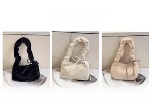 Detailed view of faux fur mini bags in black, beige, and khaki with scrunchie handles