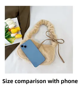 Detail view of small plush handbag with cloud-pleated handle and bow tie decoration