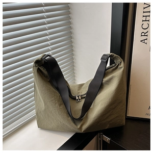 Detail view of olive green large capacity pillow bag with textured fabric and dual zippers