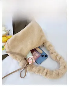 Top view of beige plush crossbody bag interior showing capacity for phone and cosmetics